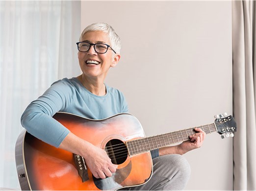 woman playing guitar music influence health